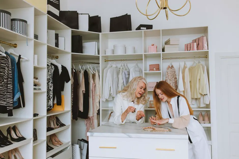 Two women at the counter of a bright boutique